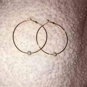 Gold hoop earring with silver diamond ball